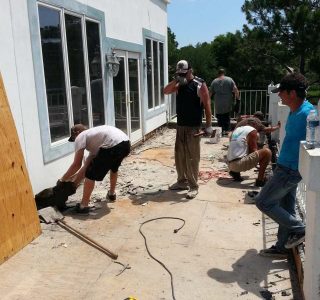Workers on job site repairing plywood decking